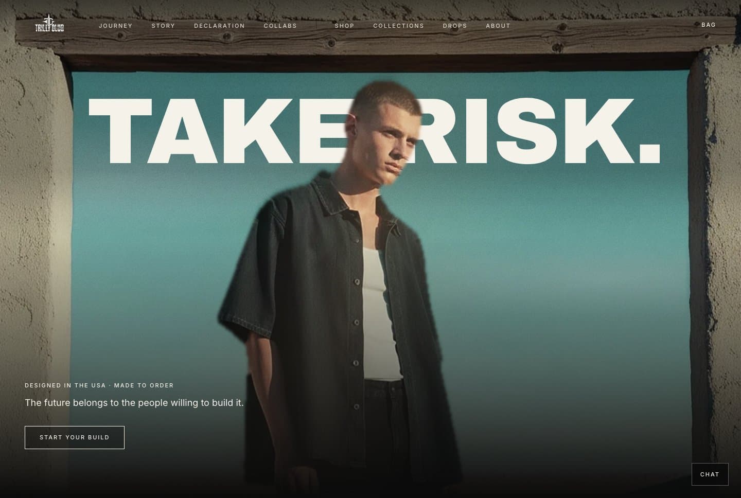 TRILLY CLUB website: the headline Take risk in giant cream capitals across a sky framed by a weathered doorway, with a figure in a dark open shirt standing in front of the words.